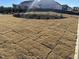 Newly seeded backyard with developing grass, young trees, and home construction in background at 11778 Salers Loop, Middlesex, NC 27557