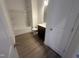 Bathroom showcasing a tub/shower, toilet, and vanity with dark cabinets and wood-look flooring at 11778 Salers Loop, Middlesex, NC 27557