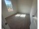 Bright bedroom featuring neutral carpeting and a window with a view of the outdoors at 11778 Salers Loop, Middlesex, NC 27557