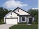 Charming home with white siding, black trim, a two-car garage, and a well-maintained lawn at 11778 Salers Loop, Middlesex, NC 27557