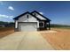 Beautifully constructed new build home with a white garage door and a concrete driveway at 11778 Salers Loop, Middlesex, NC 27557
