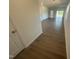 Bright hallway featuring wood flooring with an open concept and natural light at 11778 Salers Loop, Middlesex, NC 27557