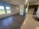 Bright kitchen and living room with wood flooring, stainless appliances, open concept, and natural light at 11778 Salers Loop, Middlesex, NC 27557