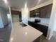 Modern kitchen with stainless steel appliances, a center island with sink, and granite countertops at 11778 Salers Loop, Middlesex, NC 27557