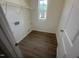 Practical laundry room with wood flooring, window, and wire shelving at 11778 Salers Loop, Middlesex, NC 27557