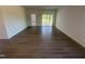 Bright and spacious living room featuring wood flooring and sliding glass doors to the outdoors at 11778 Salers Loop, Middlesex, NC 27557