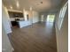 Expansive living room, wood flooring, open to kitchen with natural light from sliding glass doors at 11778 Salers Loop, Middlesex, NC 27557