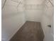 Spacious walk-in closet featuring wire shelving and neutral carpeting at 11778 Salers Loop, Middlesex, NC 27557