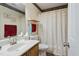 Bathroom featuring neutral decor, single sink vanity, and a shower/tub combo with a decorative curtain at 11821 Fairlie Pl, Raleigh, NC 27613