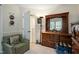 Bedroom featuring a plush chair, wooden dresser and a view leading to a bathroom at 11821 Fairlie Pl, Raleigh, NC 27613