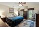 Bedroom with vaulted ceiling and ceiling fan features dark wood furniture, and a bright blue comforter at 11821 Fairlie Pl, Raleigh, NC 27613