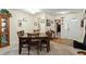 Inviting dining room with wood table set for six, adjacent to the entryway and hardwood flooring at 11821 Fairlie Pl, Raleigh, NC 27613
