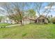 Spacious front lawn showcases this charming home, complete with mature trees and a two-car garage at 11821 Fairlie Pl, Raleigh, NC 27613