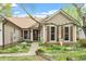 Charming exterior with inviting walkway, complemented by brown shutters and decorative landscaping features at 11821 Fairlie Pl, Raleigh, NC 27613