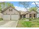 Charming home featuring a two-car garage, complemented by well-maintained landscaping and a welcoming entrance at 11821 Fairlie Pl, Raleigh, NC 27613