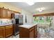 Well-lit kitchen with stainless steel fridge and adjacent breakfast nook at 11821 Fairlie Pl, Raleigh, NC 27613