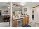 Functional kitchenette with stainless steel dishwasher and sink, with cabinets and barstool seating nearby at 11821 Fairlie Pl, Raleigh, NC 27613