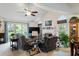 Cozy living room with vaulted ceiling, fireplace, and sliding door access to outdoors at 11821 Fairlie Pl, Raleigh, NC 27613