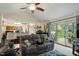Bright living room features a comfortable sofa with sliding glass doors to an outdoor deck at 11821 Fairlie Pl, Raleigh, NC 27613