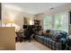 Comfortable office area featuring a sofa, desk, shelving, and a window with view to the exterior at 11821 Fairlie Pl, Raleigh, NC 27613