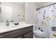 Bright bathroom with modern fixtures, floral shower curtain, and updated vanity at 120 Renee Dr, Wilson's Mills, NC 27577