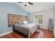 Cozy bedroom with vaulted ceilings, wood-paneled headboard, and natural light at 120 Renee Dr, Wilson's Mills, NC 27577