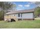 Back exterior of a home with a wooden deck, stairs, bay window, and level backyard at 120 Renee Dr, Wilson's Mills, NC 27577