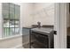 Bright laundry area features modern washer and dryer, window and white storage shelf at 120 Renee Dr, Wilson's Mills, NC 27577