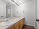 Bathroom with double sink vanity and large mirror at 1308 Aspen Falls Ct, Willow Springs, NC 27592