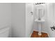 Powder room featuring modern pedestal sink, oval mirror, and fixtures at 1308 Aspen Falls Ct, Willow Springs, NC 27592