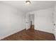 A bedroom with hardwood floors, neutral paint, and an open doorway at 1308 Aspen Falls Ct, Willow Springs, NC 27592