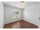 Bright bedroom with hardwood floors, neutral paint, and a large window providing ample natural light at 1308 Aspen Falls Ct, Willow Springs, NC 27592