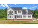 Charming two-story home with vinyl siding, a black roof, and manicured lawn on a sunny day at 1308 Aspen Falls Ct, Willow Springs, NC 27592