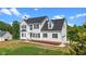 Attractive two-story home with black roof, manicured lawn and an attached garage at 1308 Aspen Falls Ct, Willow Springs, NC 27592