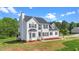 Beautiful two-story home with well-maintained lawn and mature trees surrounding the property at 1308 Aspen Falls Ct, Willow Springs, NC 27592