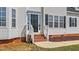 Inviting front entrance with brick steps leading to a black door, flanked by sidelights at 1308 Aspen Falls Ct, Willow Springs, NC 27592
