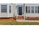 Close up on front entrance with brick steps leading to a black door at 1308 Aspen Falls Ct, Willow Springs, NC 27592