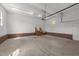 Spacious garage with brick wainscotting, windows, and multiple access points for parking and storage at 1308 Aspen Falls Ct, Willow Springs, NC 27592