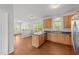 Eat-in kitchen boasts hardwood floors, wood cabinets, and island at 1308 Aspen Falls Ct, Willow Springs, NC 27592