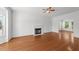 Bright and airy living room with hardwood floors, a fireplace, and abundant natural light at 1308 Aspen Falls Ct, Willow Springs, NC 27592