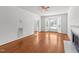 Inviting living room featuring hardwood floors, fireplace, ceiling fan and ample natural light at 1308 Aspen Falls Ct, Willow Springs, NC 27592