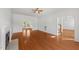 Open-concept living room with hardwood floors, fireplace, and access to staircase and porch at 1308 Aspen Falls Ct, Willow Springs, NC 27592
