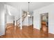 Open-concept living room showcases hardwood floors, staircase, and adjoins kitchen at 1308 Aspen Falls Ct, Willow Springs, NC 27592