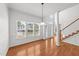 Bright living room boasts hardwood floors, large windows, and staircase at 1308 Aspen Falls Ct, Willow Springs, NC 27592