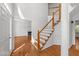 Elegant staircase featuring hardwood steps with white risers, leading to an upper level at 1308 Aspen Falls Ct, Willow Springs, NC 27592