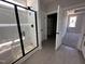 Modern bathroom featuring a glass door shower and an open closet with ample storage space at 141 Ruskin Dr, Smithfield, NC 27577