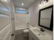 Modern bathroom features tiled floors, a shower-tub combo, and a vanity with black hardware and a framed mirror at 141 Ruskin Dr, Smithfield, NC 27577