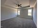 Spacious bedroom features tray ceilings, neutral paint, plush carpet and bright windows at 141 Ruskin Dr, Smithfield, NC 27577