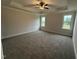 Spacious bedroom with tray ceiling, carpet and two windows for natural light at 141 Ruskin Dr, Smithfield, NC 27577