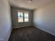 Bright bedroom features a large window, plush carpeting, and neutral paint at 141 Ruskin Dr, Smithfield, NC 27577